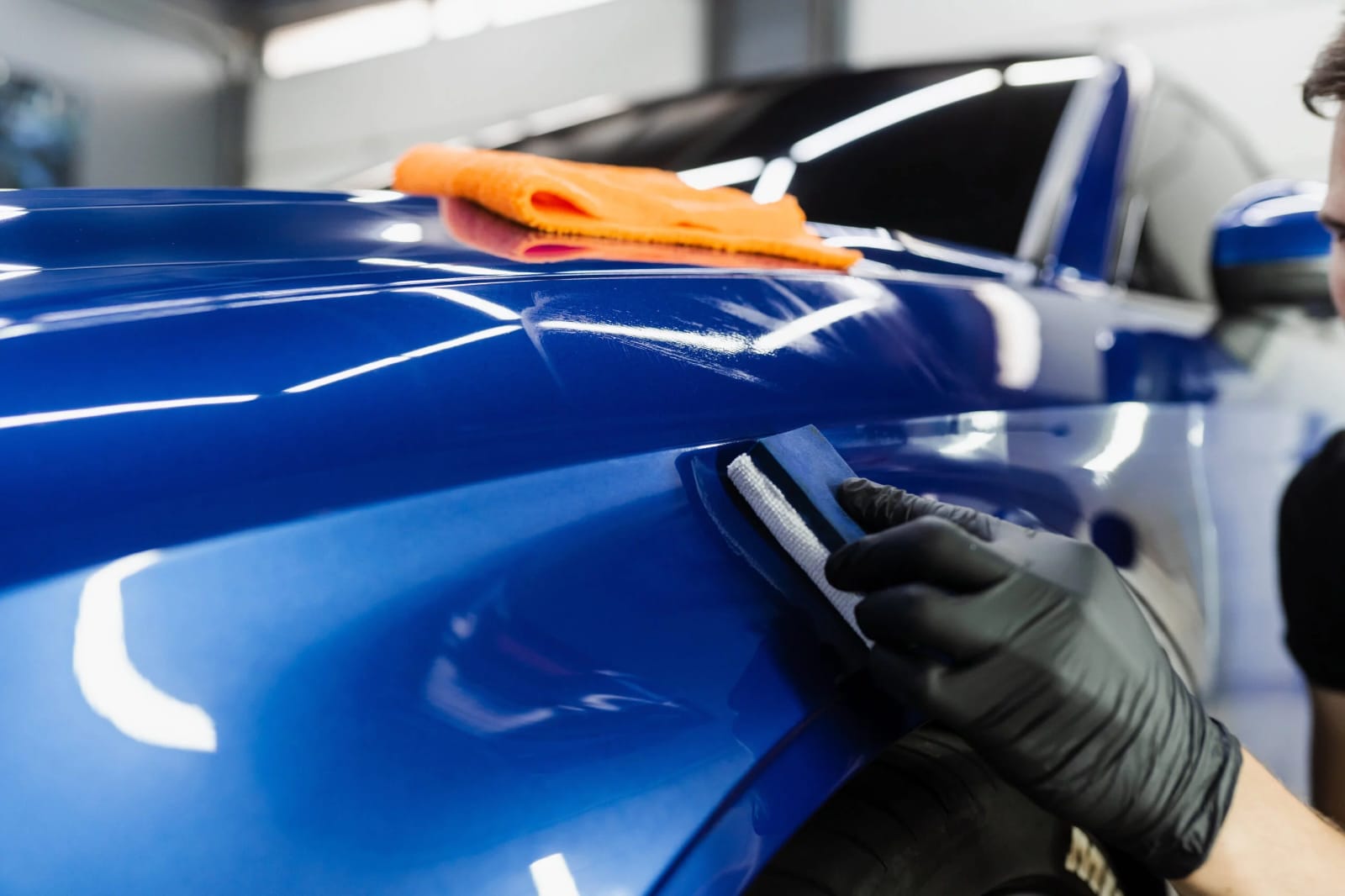 Premium ceramic coating application on glossy blue car