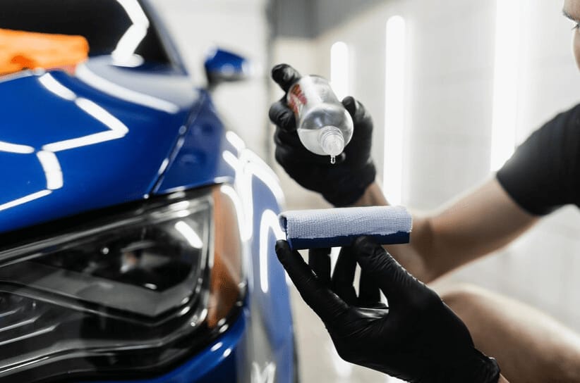 Ceramic coating being applied to blue car paint